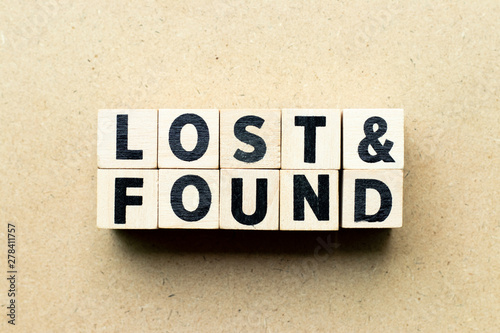 Letter block in word lost & found on wood background