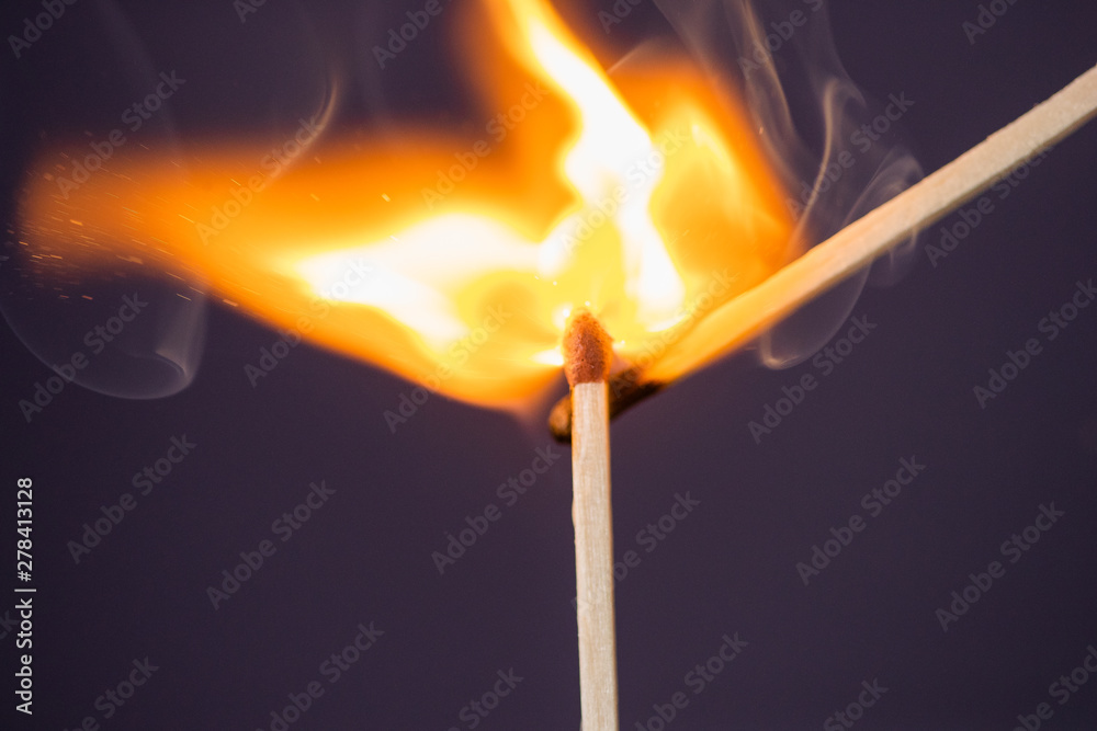 Close up Macro shot of a ignition match on a second match captured in super slow motion