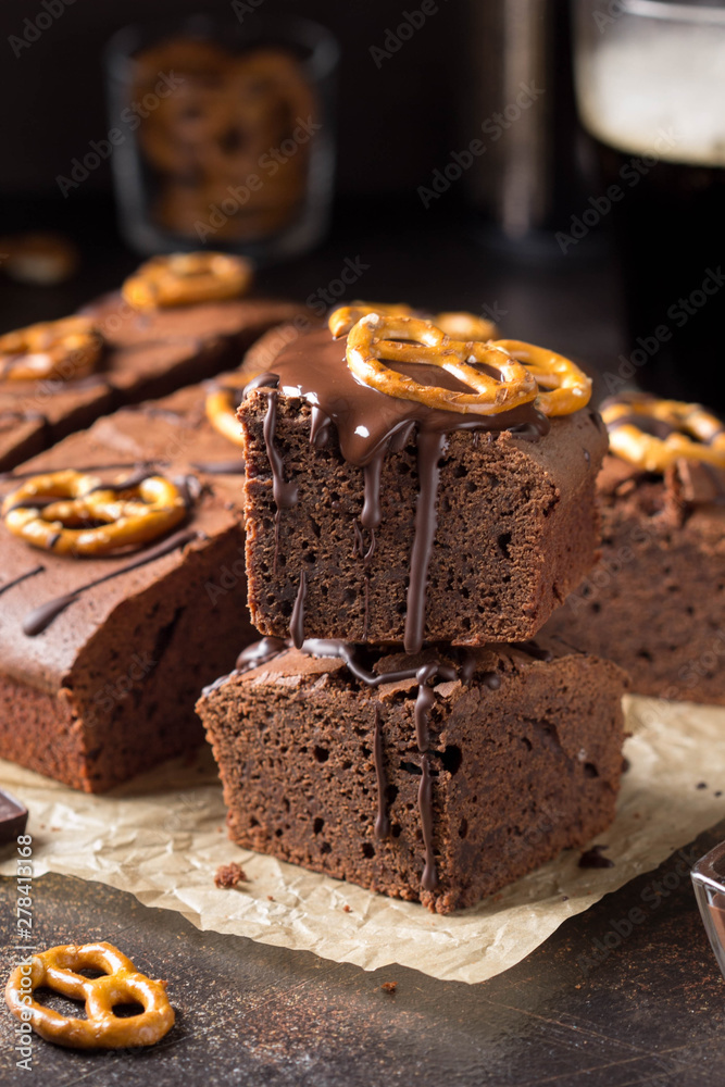 Chocolate brownie on dark beer with salted pretzels and chocolate. Delicious brutal dessert for men, sweet food