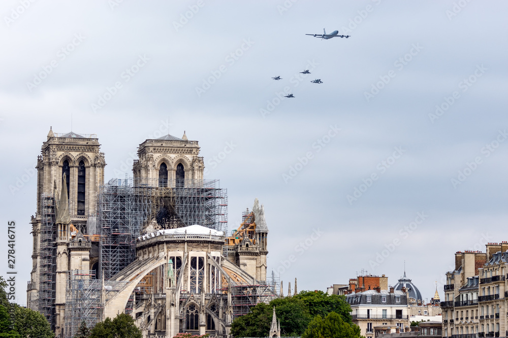 Paris, France - July 14 2019: Bastille Day Aircrafts Parade over Notre Dame de Paris while reinforcement work is in progress after the fire.