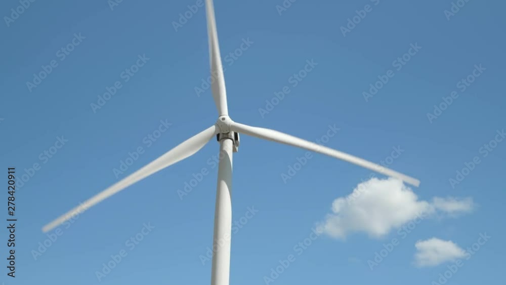 Wind generator on bright cloudy sky background Wind generator on bright cloudy sky background