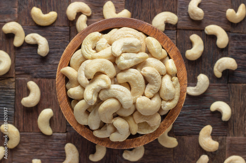 cashew nuts peeled raw in wooden bowl, top view. photo