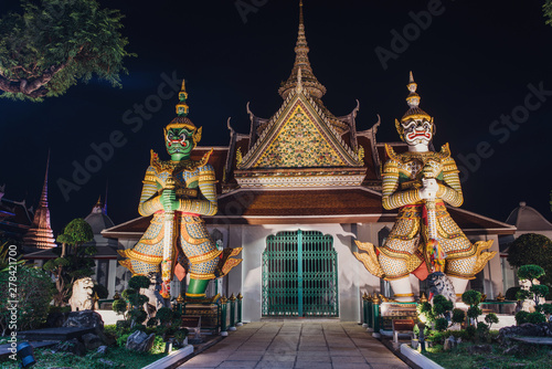 Wat Arun Temple of Dawn Buddhist temple with guardians protecting gates. Bangkok, Thailand. © undrey