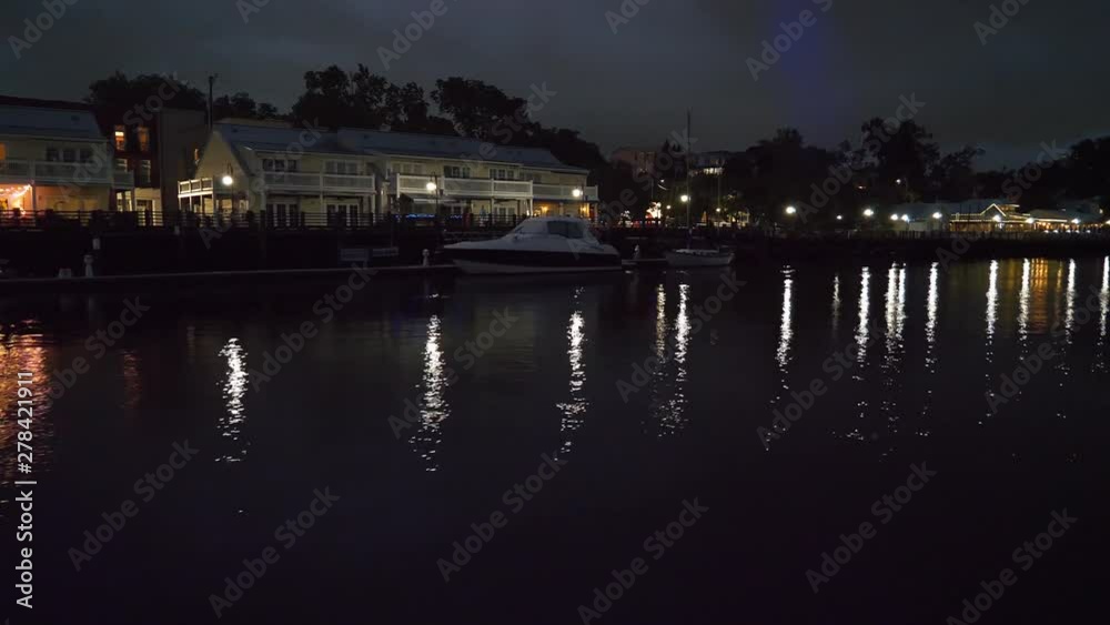 sailing along the river with the city lights glimmering on the surface of the water sailing along the river with the city lights glimmering on the surface of the water