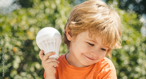Obraz na plátně Handsome boy with a light bulb