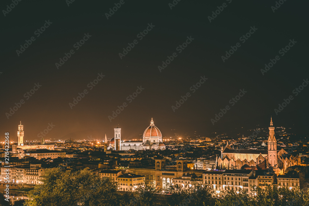 Night cityscape of Florence from a high vantage point. Florence Cathedral, Basilica of the Holy Cross and tower of Old Palace in Florence, Tuscany, Italy. 