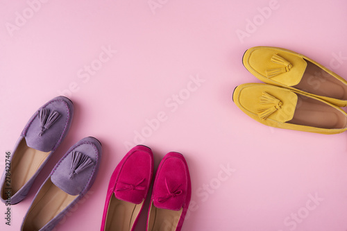 Multicolored suede moccasins shoes over pink background photo