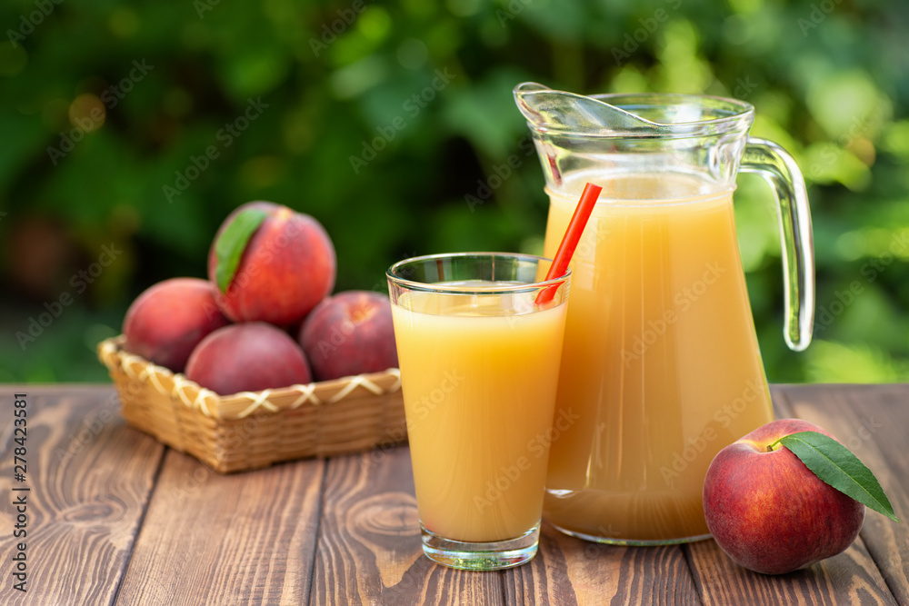 peach juice in glass and jug peach juice in glass and jug