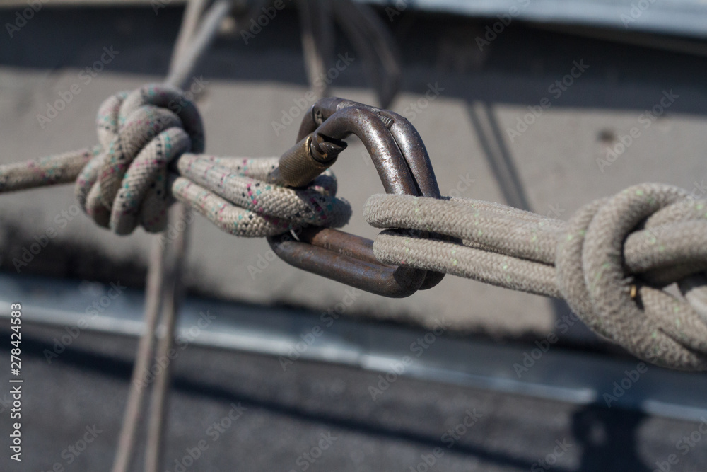 Close-up system of ropes and carbines mounted on the roof for the industrial climber, selective focus Close-up system of ropes and carbines mounted on the roof for the industrial climber, selective focus