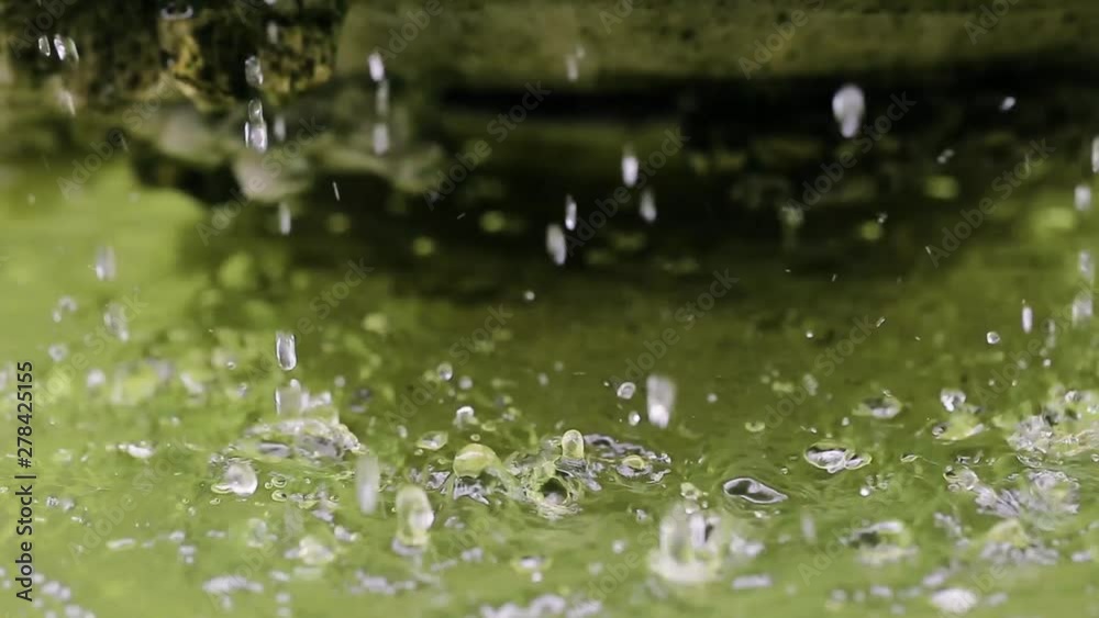 Closeup of water dropping in the fountain in the park Closeup of water dropping in the fountain in the park