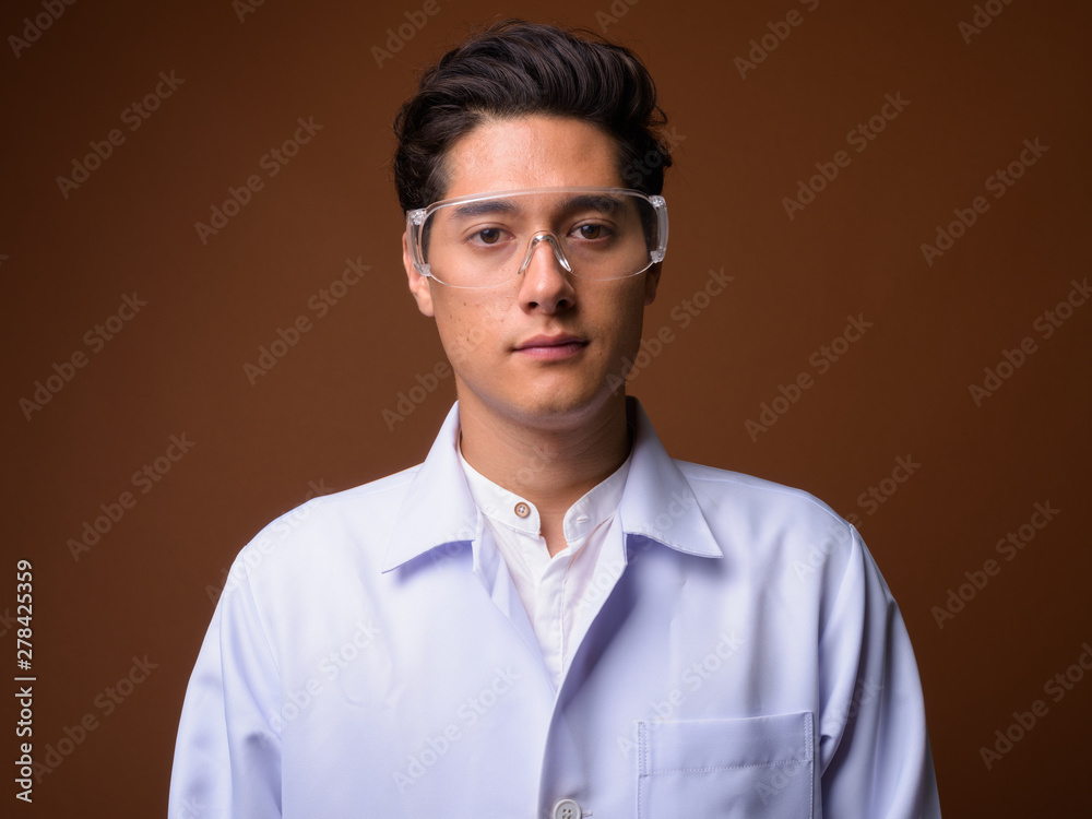 Young multi-ethnic handsome man doctor wearing protective glasse Young multi-ethnic handsome man doctor wearing protective glasse