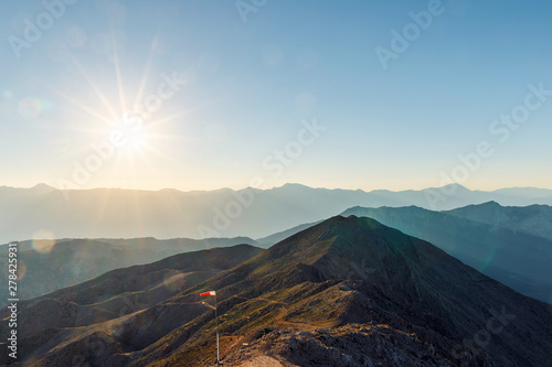 Beautiful landscape in the mountains at sunset. Lovely view of the Taurus Mountains from the top of mount Tahtali at sunset. Kemer, Turkey. Postcard view