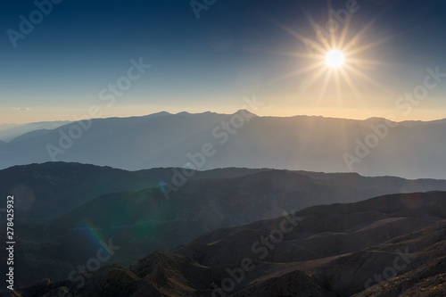 Beautiful landscape in the mountains at sunset. Lovely view of the Taurus Mountains from the top of mount Tahtali at sunset. Kemer, Turkey. Postcard view