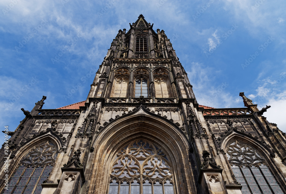 Front facade of St Lambert's Church against blue sky located in Muenster, Germany