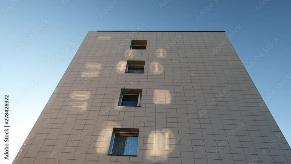 The wall of the renovated building is illuminated by sunlight reflections. Slow motion The wall of the renovated building is illuminated by sunlight reflections. Slow motion