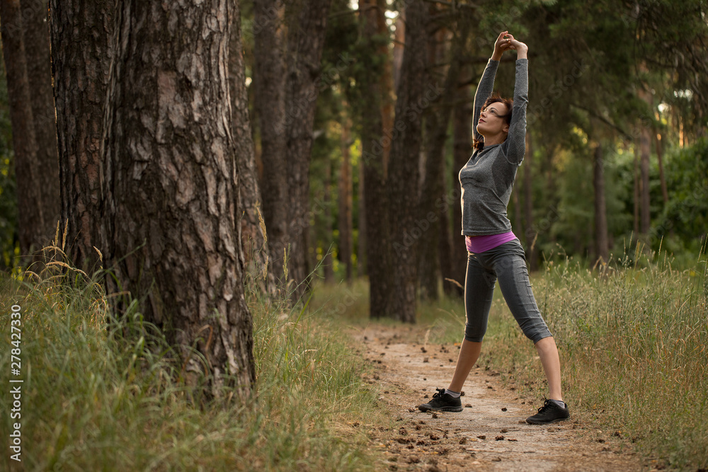 The girl takes up sports in nature. running in the woods. The girl takes up sports in nature. running in the woods.