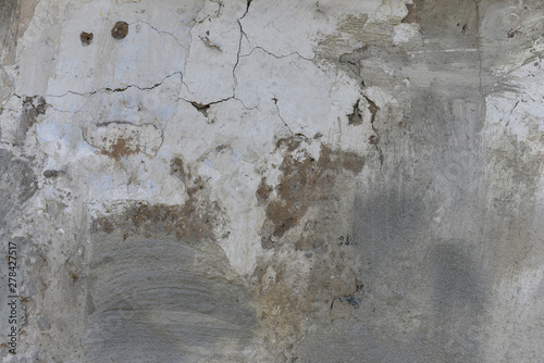 Old damaged wall background textere. Fragile plaster fragments, scratches, cracks, roughness. Design backdrop concept Copy space photo
