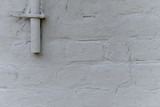 Old white roughly created brick wall painted with white paint, close up, copy space