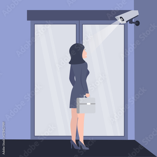 Checkpoint with a surveillance camera and system for the identification of people. Identification of businesswoman. Modern technology security. Scan at the input.  Biometric facial recognition system.