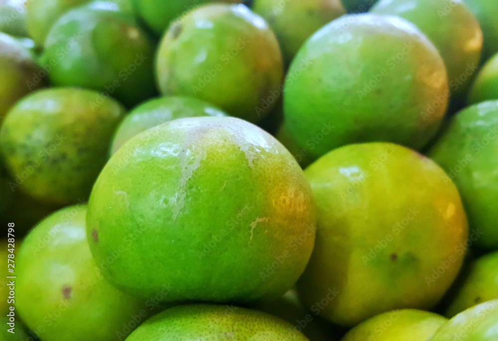 green lemon in market background, closeup view green lemon in market background, closeup view