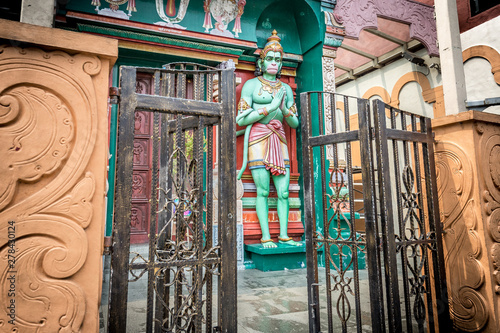 Open gates in front of the Hanuman Hindu green monkey god sculpture outside the entrance of the Sri Vadapathira Kaliamman Temple on Serangoon Road in Little India, Singapore, Asia photo