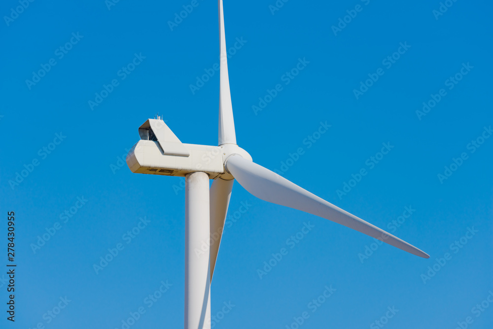 Wind Generator Turbine on the Blue Sky Bacground. Green Renewable Energy Concept. Wind Generator Turbine on the Blue Sky Bacground. Green Renewable Energy Concept.
