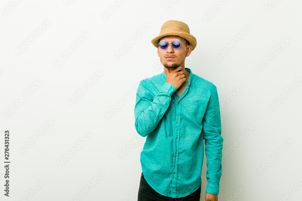 Young hispanic man wearing a summer clothes suffers pain in throat due a virus or infection. Young hispanic man wearing a summer clothes suffers pain in throat due a virus or infection.