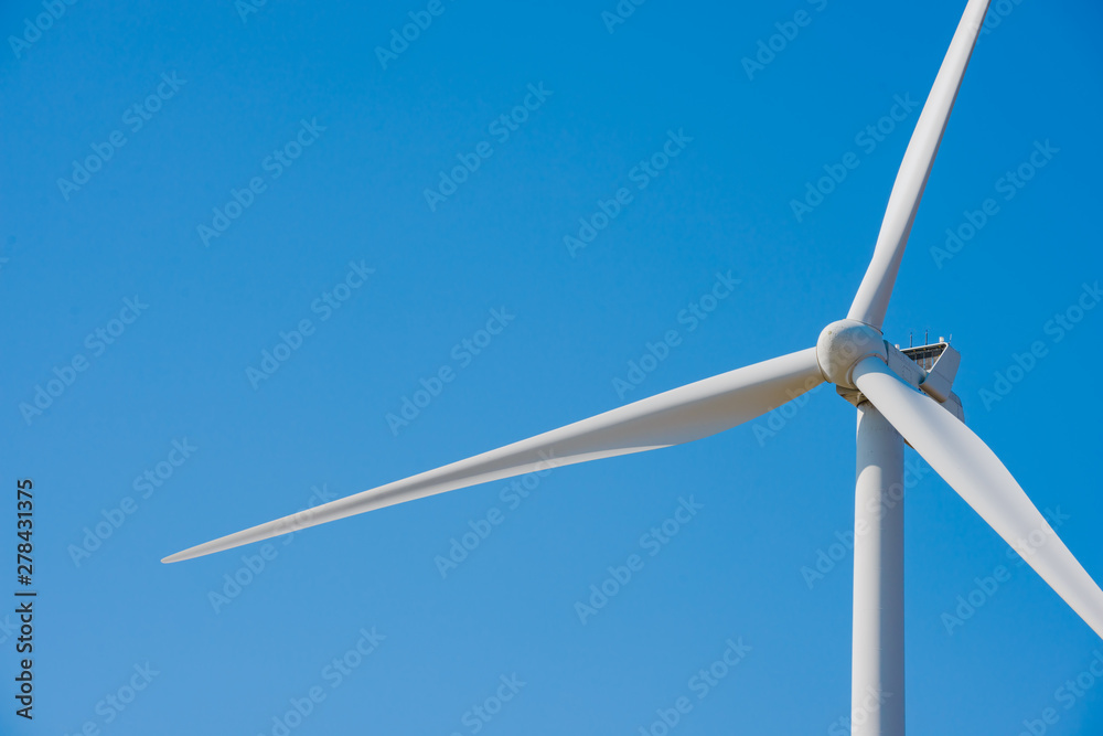 Wind Generator Turbine on the Blue Sky Bacground. Green Renewable Energy Concept. Wind Generator Turbine on the Blue Sky Bacground. Green Renewable Energy Concept.