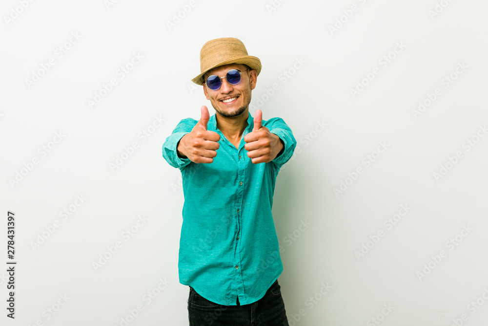 Young hispanic man wearing a summer clothes with thumbs ups, cheers about something, support and respect concept.