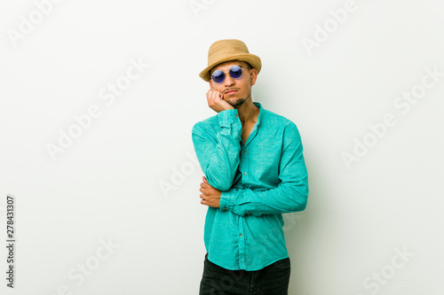 Young hispanic man wearing a summer clothes who is bored  fatigued and need a relax day.