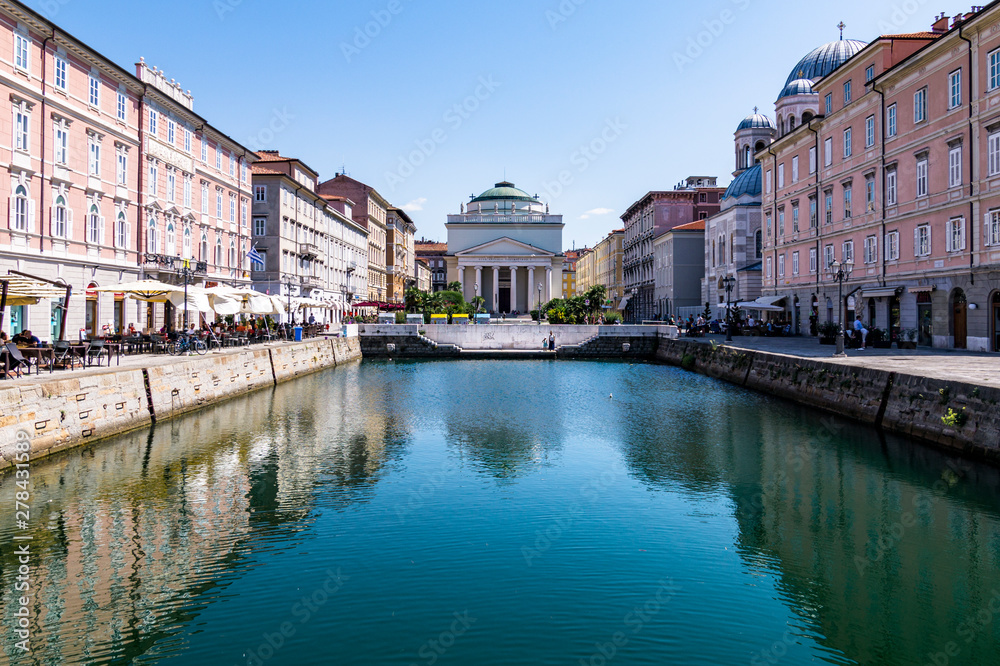 Grand Canal of Trieste with turquoise waters and the church San't Antonio Nuovo, Trieste, Italy