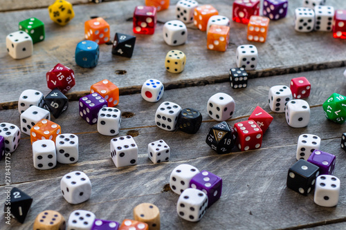 A bunch of dice on a wood background