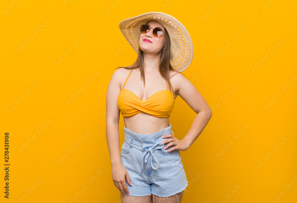 Young caucasian woman wearing a straw hat, summer look dreaming of achieving goals and purposes Young caucasian woman wearing a straw hat, summer look dreaming of achieving goals and purposes