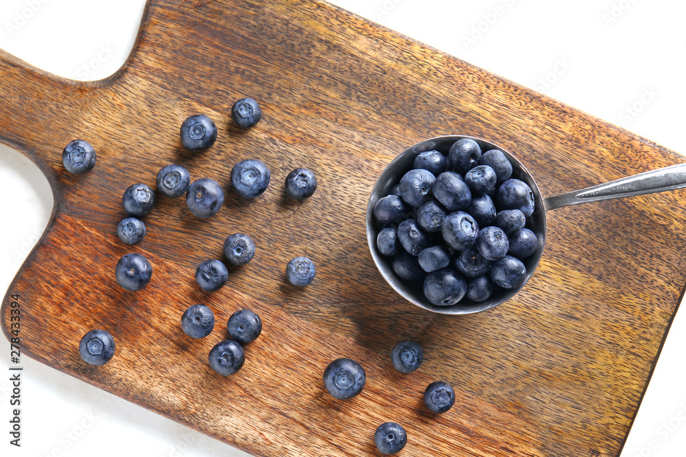 Scoop with fresh blueberry on wooden board Scoop with fresh blueberry on wooden board