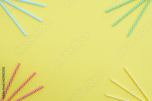 Cocktail tubes on yellow background.