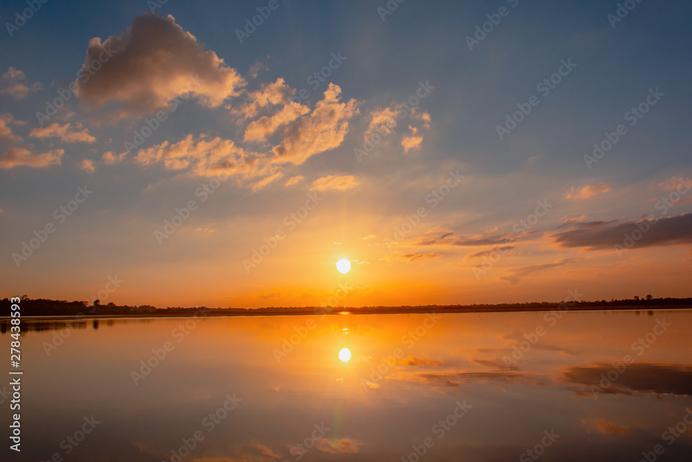 Sunset reflection lagoon. beautiful sunset behind the clouds and blue sky above the over lagoon landscape background. dramatic sky with cloud at sunset Sunset reflection lagoon. beautiful sunset behind the clouds and blue sky above the over lagoon landscape background. dramatic sky with cloud at sunset