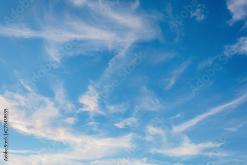 Cirrus clouds on blue sky background.