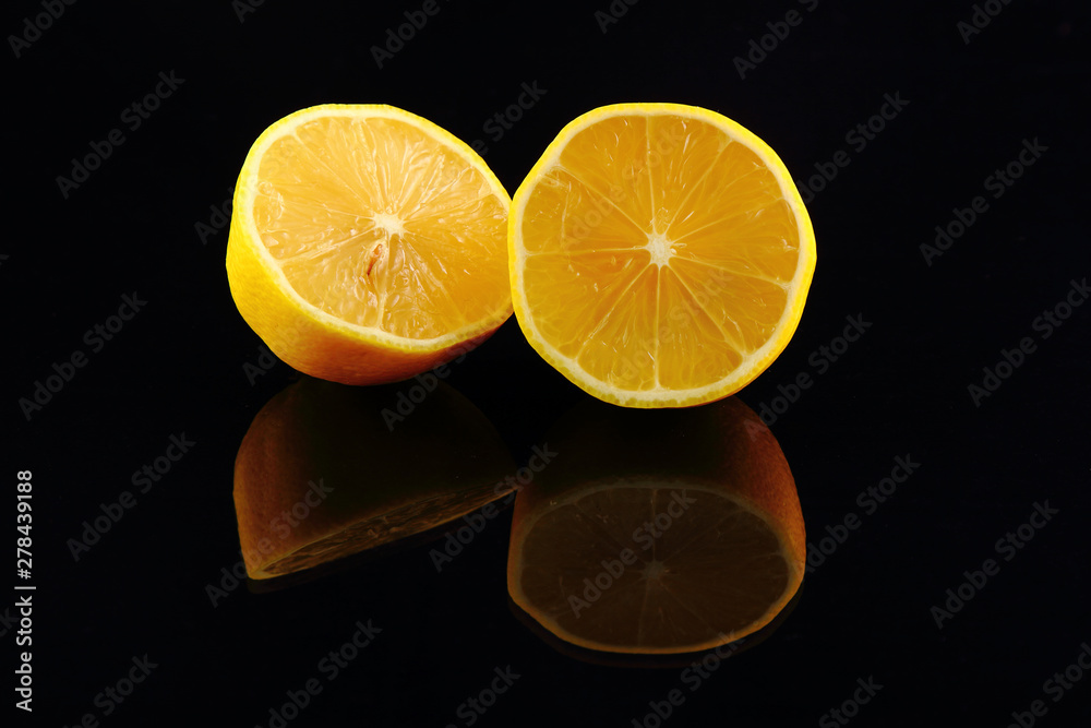 Photo of illuminated lemons with reflection on dark background Photo of illuminated lemons with reflection on dark background