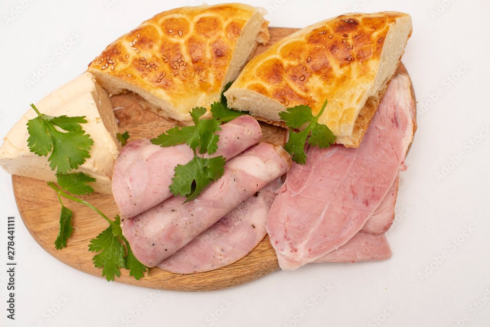 soft cheese, slices of meat and flatbread