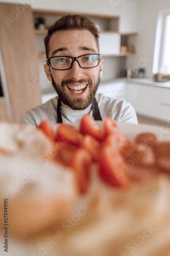 plate of sandwiches in the hands of an attractive man