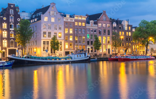 Night city view of Amsterdam canal, typical dutch houses and boats, Holland, Netherlands. © kovalenkovpetr