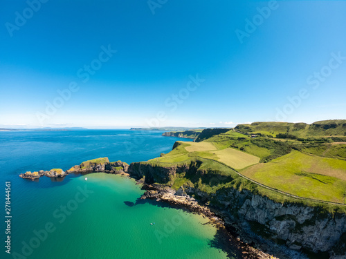 Carrick a Rede Rope Bridge in Ballintoy Northern Ireland. Aerial view on Cliffs and turquoise Atlantic Ocean water