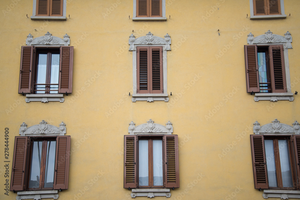 Decorated windows of a historical building in Caravaggio, Italy