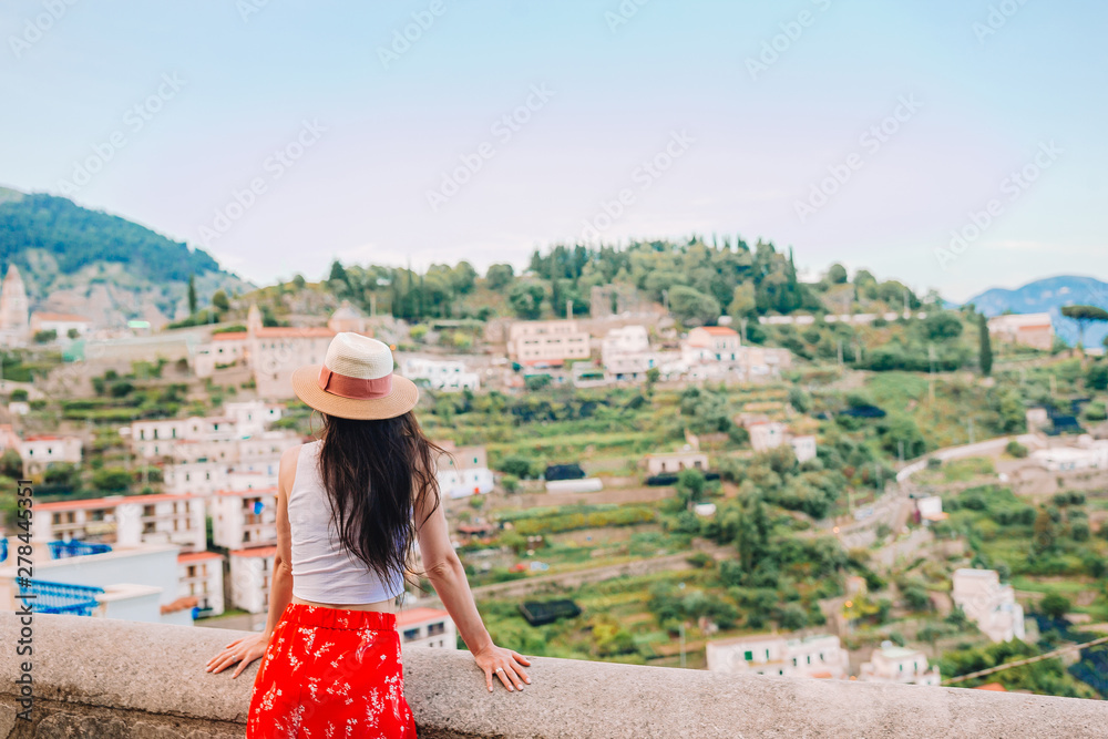 Summer holiday in Italy. Young woman in Positano village on the background, Amalfi Coast, Italy