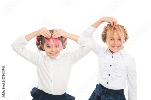 Fancy hairstyles. Cute little children styling funny hairstyles isolated on white. Adorable small girls with long braided hairstyles. Crazy kids making fun with hairstyles photo