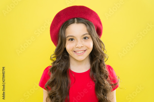 Adding an edge to the classic French look. Small child smiling with fashion look. Happy little girl wearing red beret for the ultimate cool girl look. Trendy look © be free