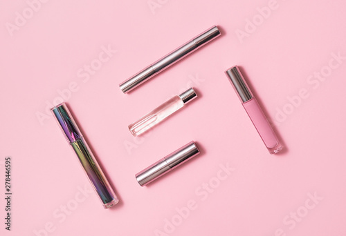 Flat lay composition with decorative makeup products and parfume on pink background. Makeup and beaty concept. Copy space.