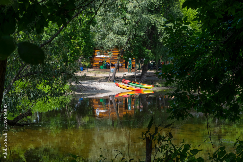 Kayaks, boats on the river bank. Beautiful nature. Healthy lifestyle. Kayaks, boats on the river bank. Beautiful nature. Healthy lifestyle.