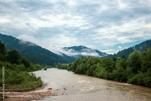 River in the mountains, sky, summer. Ukraine, the Carpathian Mountains. Concept of travel, tourism, holidays, vacation