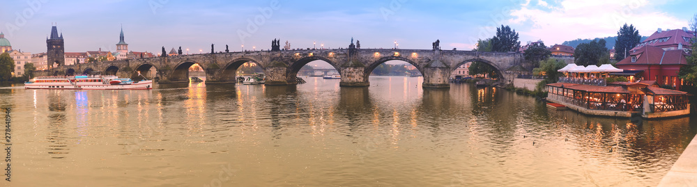 Panoramic image of Charles bridge in Prague in the evening